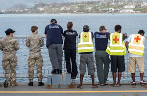 NZMAT and other volunteers looking across the water to the coast. 