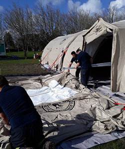 Volunteers setting up the tent facility. 