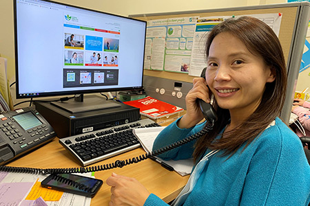 Mira Kim, volunteer with Asian Healthline, on a call. 
