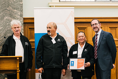 Three Kaikohe Health Shuttle volunteers accepting their award from Minister Little. 
