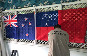 A logistics volunteer, by the NZ and Samoan flags. 