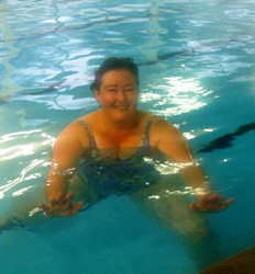 Photo of a woman enjoying a swim in the pool. 