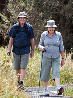 An older couple out on a nature walk. 