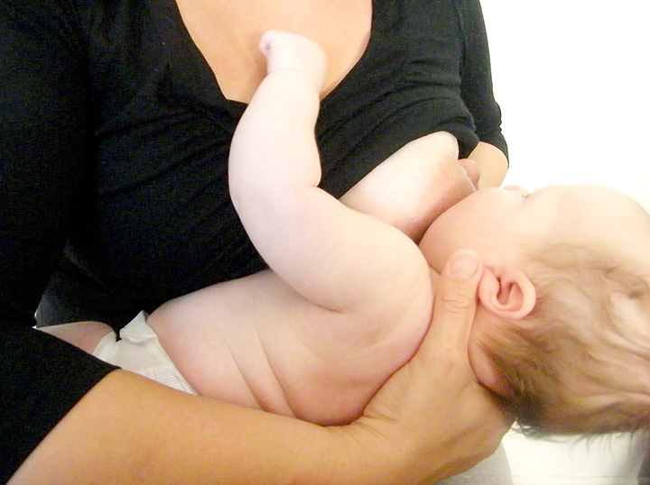 Breastfeeding mother and baby - cross-cradle position