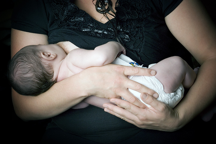 Breast feeding mother, cradle hold. 