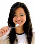 Photo of a young woman about to brush her teeth. 