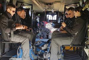 Volunteers in a helicoptor for deployment.
