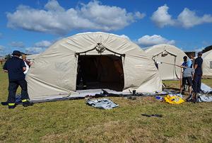 Trainees setting up a tent facility.