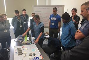 Group gathered around a table on a training course.