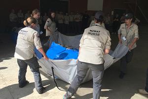 Volunteers moving a tarp.